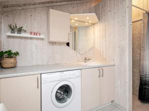 a kitchen with a washing machine and a sink at 10 person holiday home in Humble-By Traum in Humble