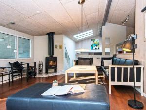 a living room with a couch and a fireplace at 10 person holiday home in Glesborg in Fjellerup Strand