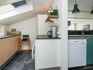 a kitchen with a white refrigerator and a sink at 5 person holiday home in Hemmet in Falen
