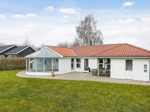 a white house with a red roof at 8 person holiday home in Juelsminde in Sønderby