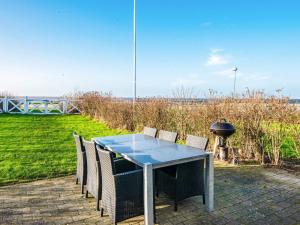 a blue table and chairs with a grill and a grill at 7 person holiday home in Hemmet in Falen
