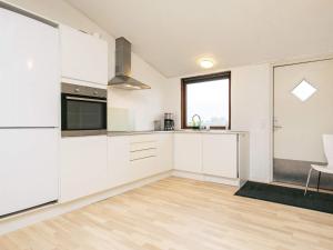 una cocina vacía con armarios blancos y una ventana en 16 person holiday home in Brovst, en Brovst