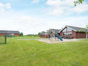 um parque infantil com um escorrega num quintal em 18 person holiday home in Nordborg em Nordborg