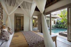 1 dormitorio con cama y piscina en The Sun of Granary Resort and Villas, en Ubud