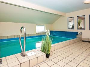 a large swimming pool in a room with a tub at Four-Bedroom Holiday home in Hemmet 14 in Falen