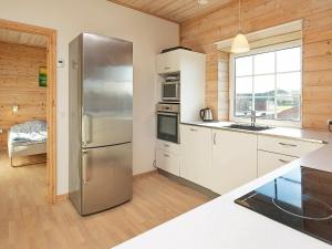 a kitchen with a stainless steel refrigerator and a window at 10 person holiday home in Bagenkop in Bagenkop