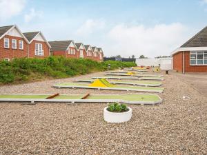 a row of surfboards are lined up on the ground at 6 person holiday home in R m in Rømø Kirkeby