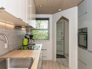 a kitchen with a sink and a window at 10 person holiday home in Juelsminde in Sønderby