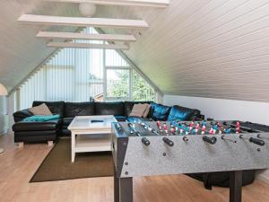 a living room with a ping pong table at 8 person holiday home in Ulfborg in Fjand Gårde
