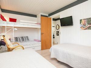 a bedroom with two beds and a flat screen tv at Two-Bedroom Holiday home in Jerup 6 in Jerup