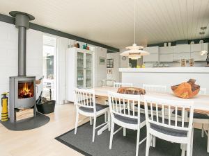 a kitchen with a fireplace and a table and chairs at Two-Bedroom Holiday home in Jerup 6 in Jerup