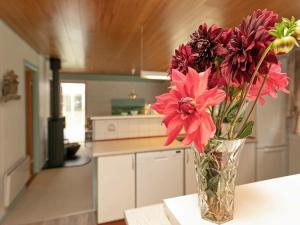 a vase of flowers sitting on a table in a kitchen at 8 person holiday home in Bl vand in Ho