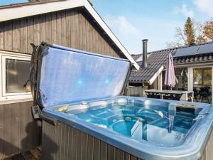 a hot tub on the side of a house at 6 person holiday home in Ebeltoft in Øksenmølle