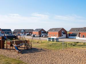 a playground in front of a row of houses at Seaside Retreat at Rim - By Traum Ferienwohnungen in Rømø Kirkeby