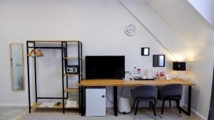 a room with a desk with a computer and chairs at Mina Hotel Arbat in Vladivostok