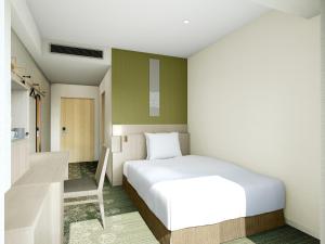 a bedroom with a white bed and a chair at Shinjuku Prince Hotel in Tokyo