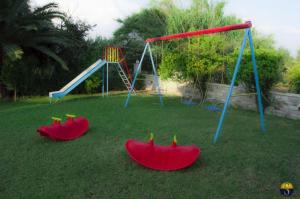 a group of playground equipment in a yard at Hotel Sias Resort in Agios Avgoustinos