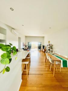 a kitchen and dining room with a table and chairs at 734 apartment-2 bedroom and 2 bathroom accommodation, sleeps 4 in Margaret River Town