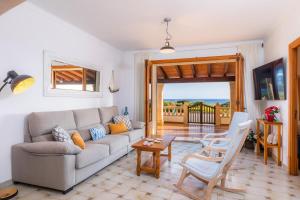a living room with a couch and a table at Casa vacacional Es Vell Marí in Sa Ràpita