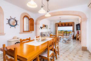 a dining room and living room with a table and chairs at Casa vacacional Es Vell Marí in Sa Ràpita
