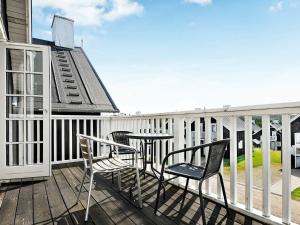 a patio with two chairs and a table on a deck at 8 person holiday home in Gjern in Gjern