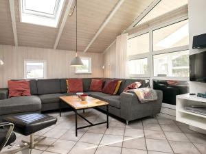 a living room with a couch and a table at 8 person holiday home in Vejers Strand in Vejers Strand