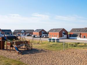 a playground in front of a row of houses at Holiday Home Vestergade VII in Sønderby