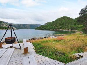 a wooden pier with a view of a lake at 8 person holiday home in Sundlandet in Snildal