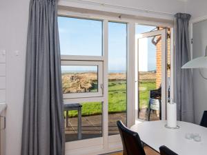 a dining room with a view of the ocean at Beautiful Holiday Home in HÃ¸jer with Terrace in Emmerlev