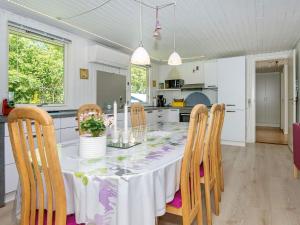 a kitchen and dining room with a table and chairs at 6 person holiday home in Ringk bing in Nørby