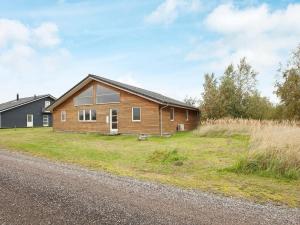 a wooden house on the side of a road at 10 person holiday home in Rødby-By Traum in Rødby
