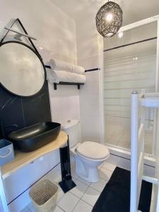 a bathroom with a sink and a toilet and a shower at Les Villas de la Plage in Névez +21 photos