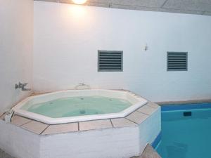 a jacuzzi tub in a room with a pool at 14 person holiday home in Glesborg in Glesborg