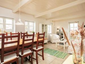 a dining room and living room with a table and chairs at Holiday home Humble in Humble