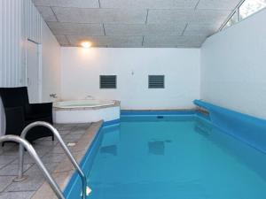 a large swimming pool with a tub in a room at 14 person holiday home in Glesborg in Glesborg