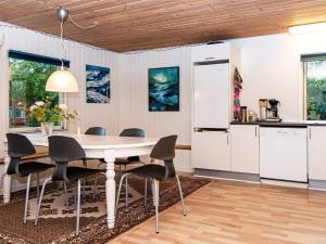 a kitchen and dining room with a table and chairs at 6 person holiday home in Hemmet in Hemmet