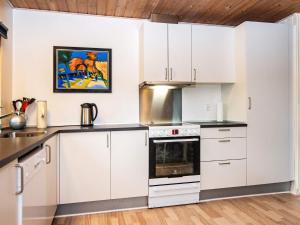 a kitchen with white cabinets and a stove at 6 person holiday home in Hemmet in Hemmet