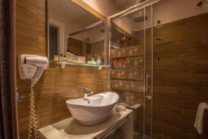 a bathroom with a sink and a shower at Pirrion Wellness Boutique Hotel in Ano Pedina