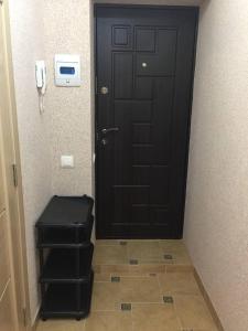 una puerta negra con un taburete delante en Apartament simplu si confortabil, en Chişinău