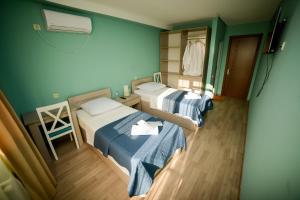 a hospital room with two beds and a chair at Lemon in Kutaisi