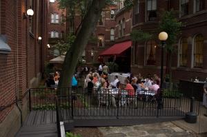 
people sitting around a picnic table at The Priory Hotel in Pittsburgh
