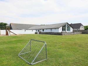 a soccer goal in a field in front of a house at 20 person holiday home in Vinderup in Vinderup
