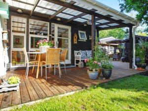 a wooden deck with a table and chairs on it at 6 person holiday home in Hemmet in Hemmet