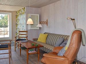 a living room with a couch and a table at 4 person holiday home in Fan in Fanø