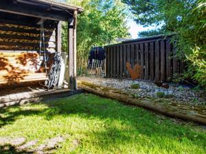 a backyard with a fence and a yard with grass at 6 person holiday home in Hemmet in Hemmet