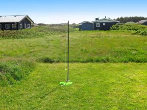 a baseball bat in the middle of a field at 6 person holiday home in Harbo re in Harboør