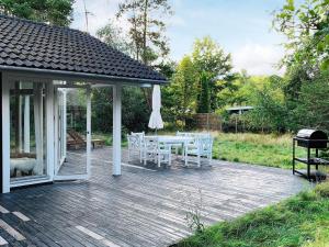 a pavilion with a table and chairs on a deck at 8 person holiday home in Gedser in Gedser