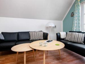 a living room with a couch and a table at 6 person holiday home in Grenaa in Grenå