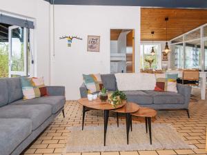 ein Wohnzimmer mit einem Sofa und einem Tisch in der Unterkunft 12 person holiday home in Ebeltoft in Ebeltoft