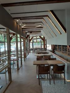 a dining room with tables and chairs and windows at Motel Bajra in Travnik